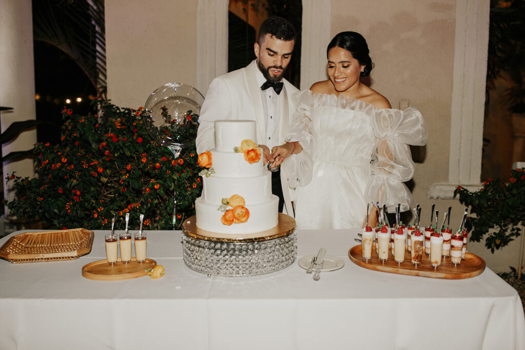 Bride and groom cut the cake at wedding reception 